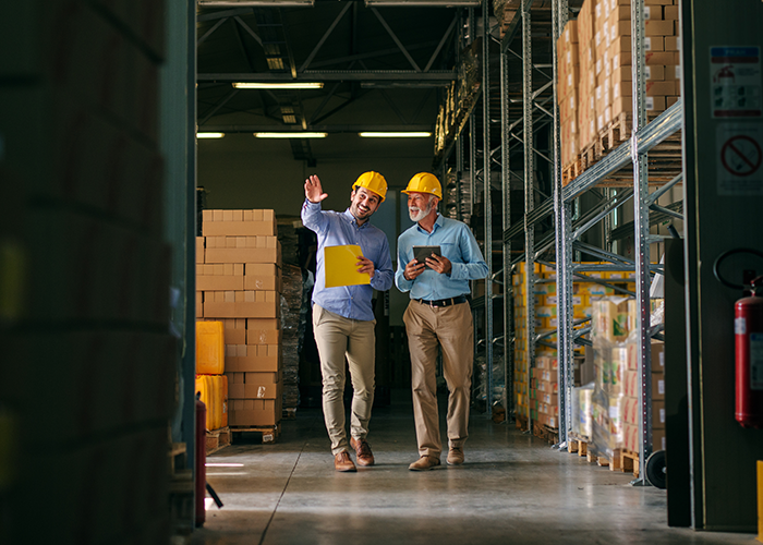 Two men walking in a warehouse